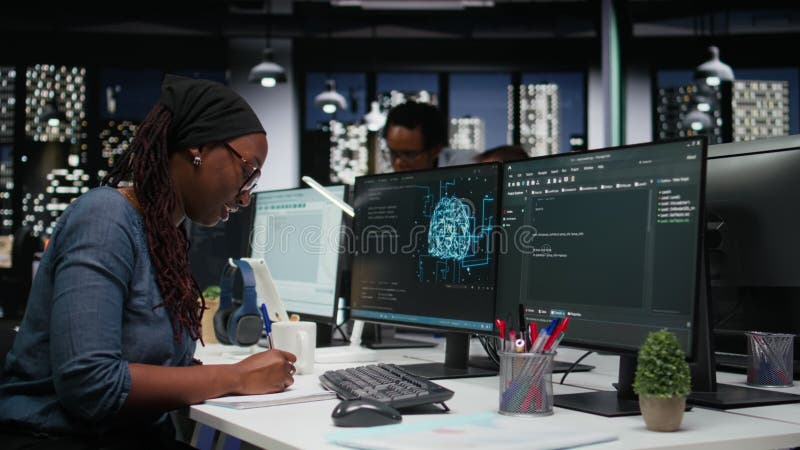 Software developer in office using laptop to fix artificial intelligence bugs stock video