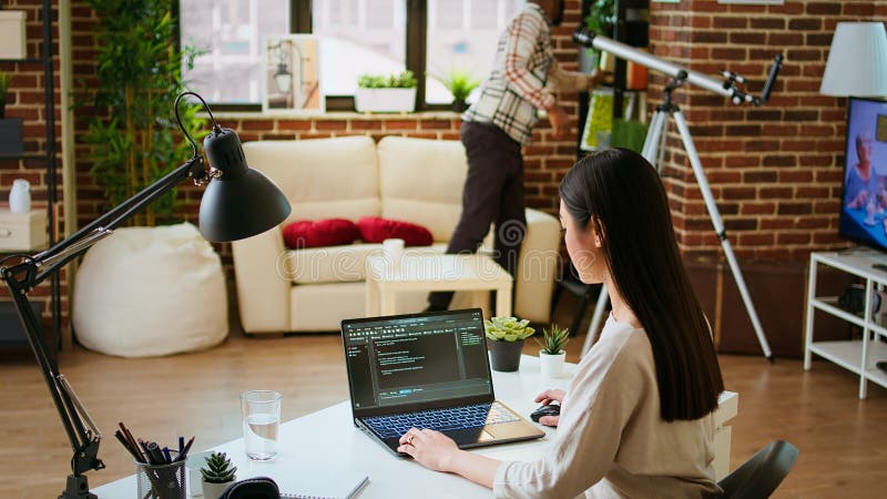 Software developer types programming code in a cozy home office setup stock photos
