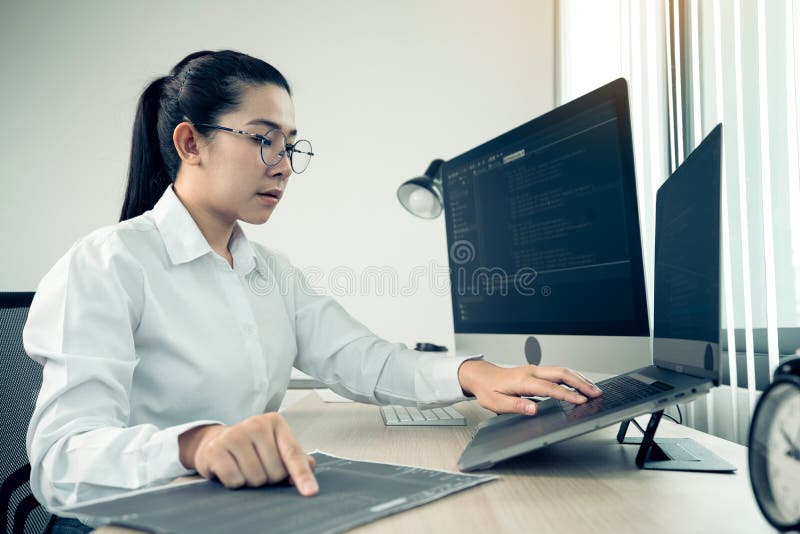 Software developers are analyzing about the code written into the program on the computer in office room royalty free stock photos