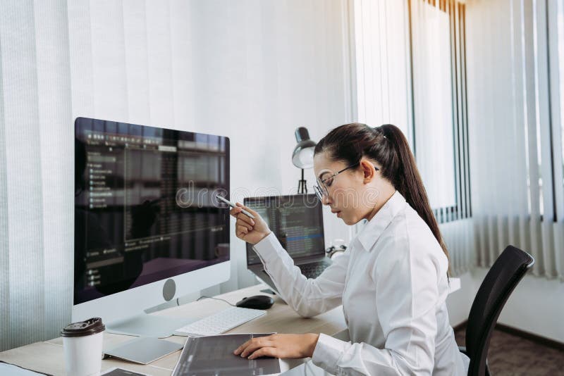 Software developers are analyzing about the code written into the program on the computer in office room royalty free stock images
