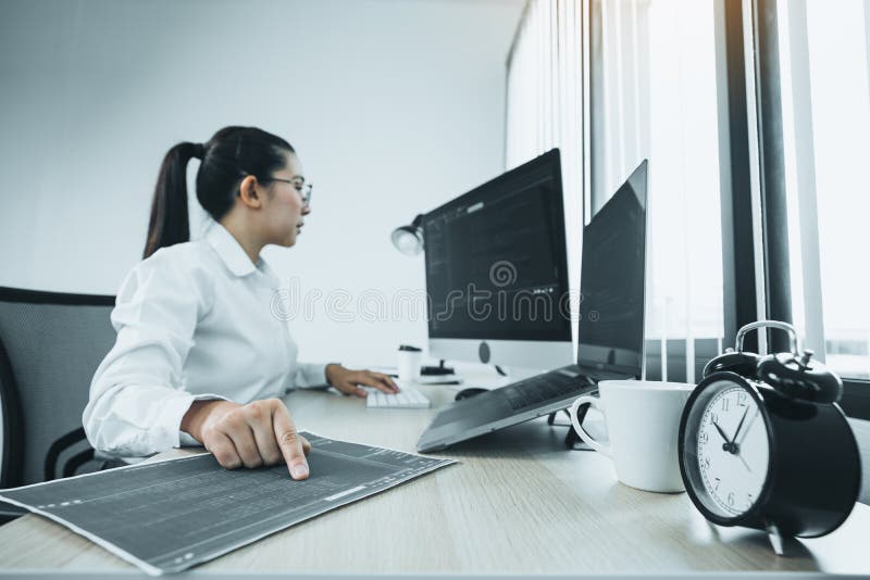 Software developers are analyzing about the code written into the program on the computer in office room stock images