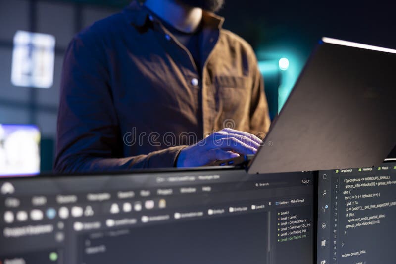 Software technician checking code displayed on computer displays, close up royalty free stock images