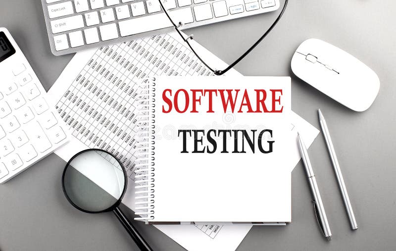 SOFTWARE TESTING text on notepad on chart with keyboard and calculator on grey background stock photography