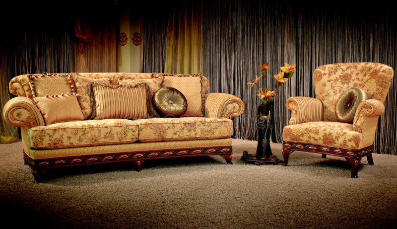 Stylish vintage armchair and sofa with pillows and flower in the vase. Stylish vintage armchair and sofa with pillows and flower in the vase