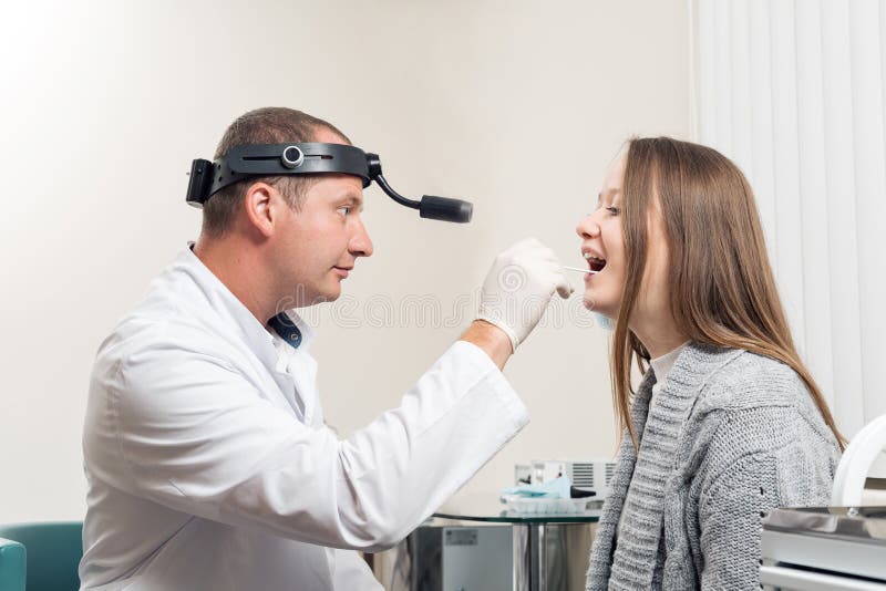Soignez ENT vérifiant l'oreille avec l'otoscope à la patiente de femme Clinique privée Oto-rhino-laryngologiste
