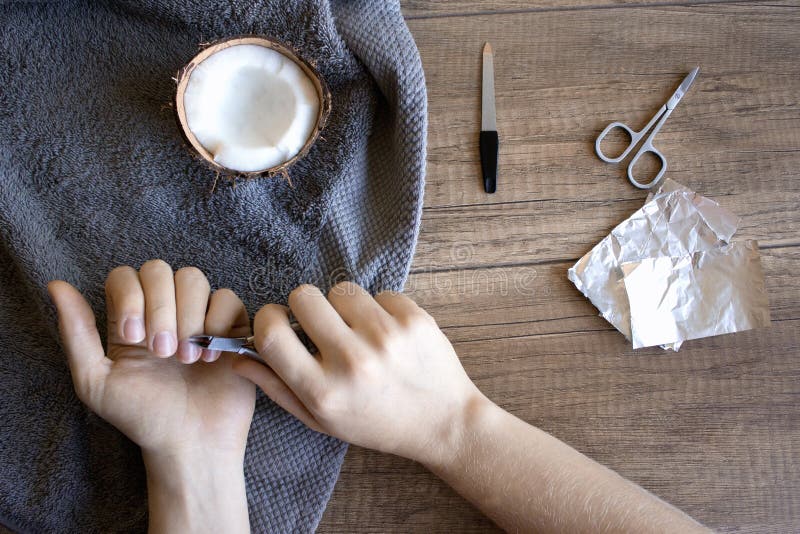 Soin de main, soin folklorique de main Manucure avec de l'huile de noix de coco, outils de manucure : ciseaux, dossier d'ongle Dé images stock Soin de main, soin folklorique de main Manucure avec de l'huile de noix de coco, outils de manucure : ciseaux, dossier d'ongle Dé images stock