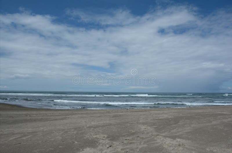 Sojourning vista on picturesque Siletz Bay Beach, pacific ocean and a partly cloudy sky, along the prominent Oregon central coast. Sojourning vista on picturesque Siletz Bay Beach, pacific ocean and a partly cloudy sky, along the prominent Oregon central coast.