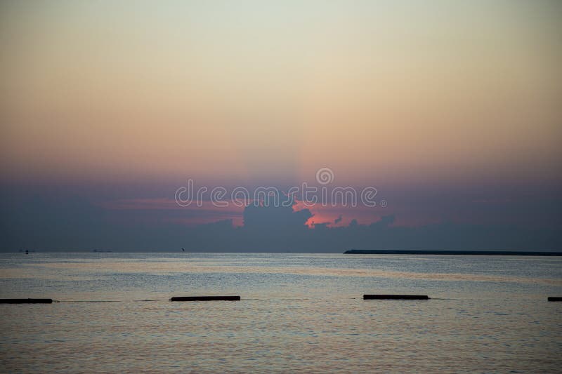 Sol por trás das nuvens acima do oceano imagens de stock