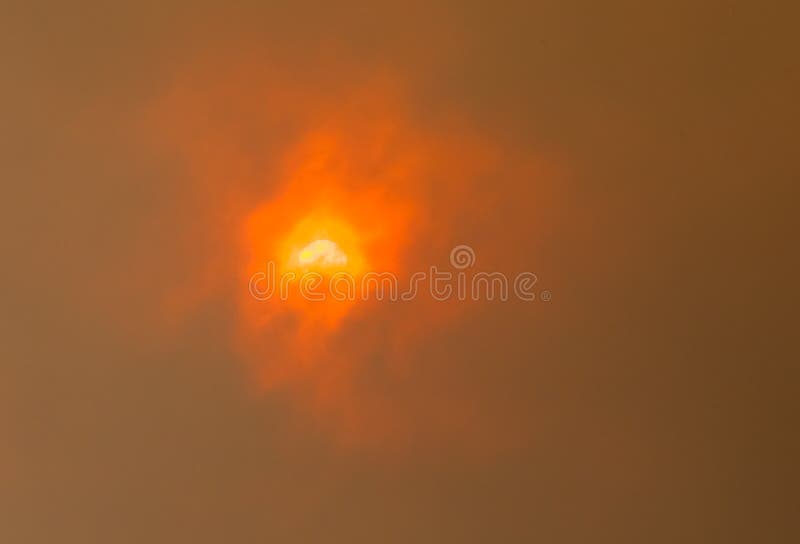 Vivid and dramatic orange sun through clouds of smoke from an Australian bushfire. Vivid and dramatic orange sun through clouds of smoke from an Australian bushfire