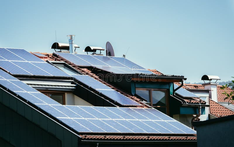 Blue-black solar cells and photovoltaic cells on the rooftop of an apartment house stock images Blue-black solar cells and photovoltaic cells on the rooftop of an apartment house stock images