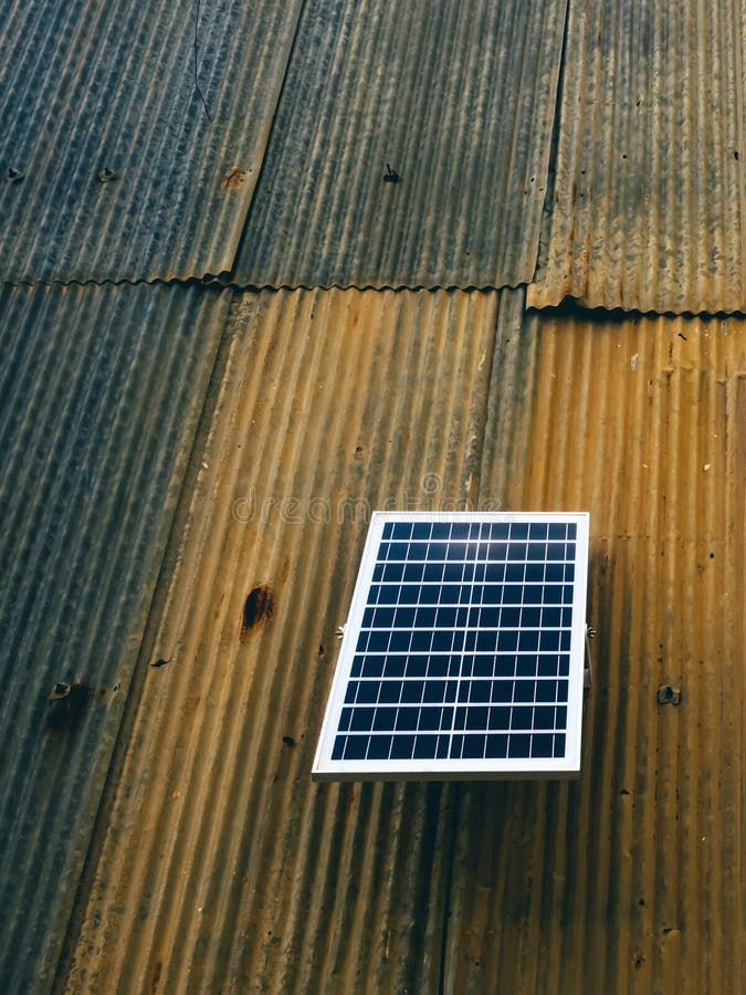 Solar Panel Attached on Old Zinc Wall. Electric Solar Panel on the
