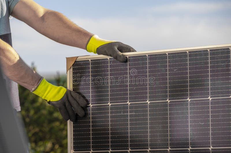 Solar Panel in the Hands of a Worker .Fitting and Installation of Solar
