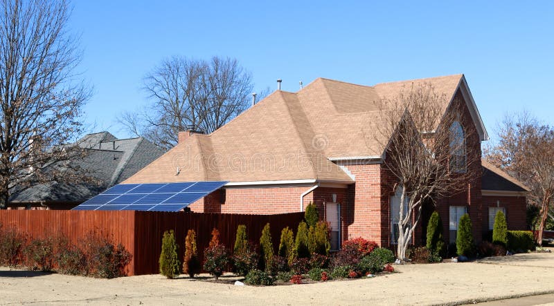 A Solar Panel powers a Middle Class Suburban Home stock photography