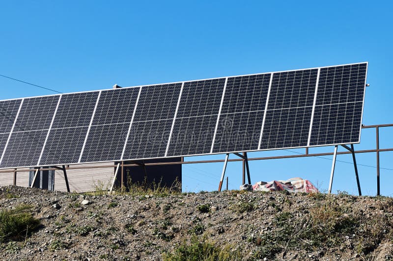 Solar Panels Installed Near the House on the Mountainside Stock Image