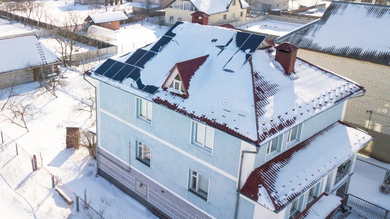 Solar panels on the roof of the house after a heavy snowfall in the winter