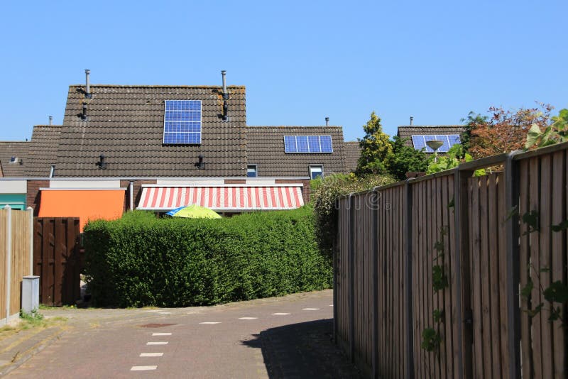 Solar panels on the roof of the houses in the summer.