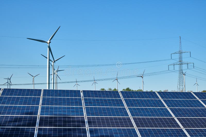 Solar panels, wind turbines and overhead power lines stock photo