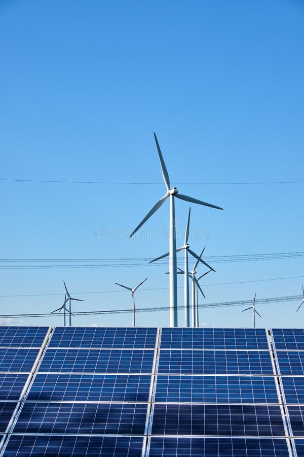 Solar panels, wind turbines and power lines stock photography