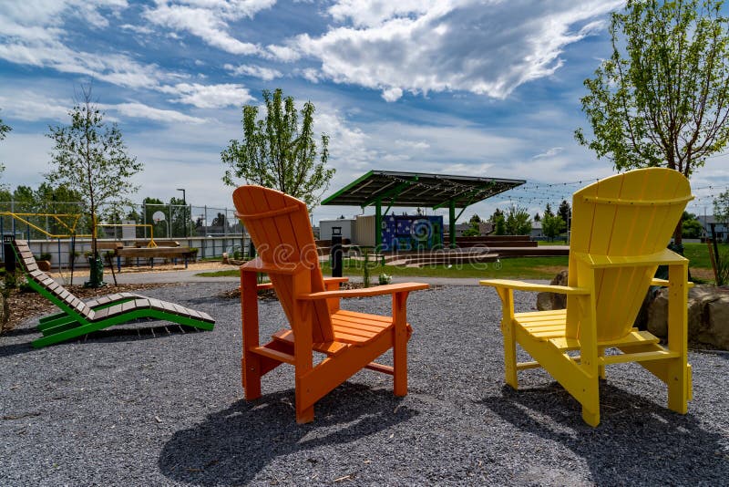 Solar Rooftop Amphitheater between Two Painted Wooden Adirondack Chairs ...