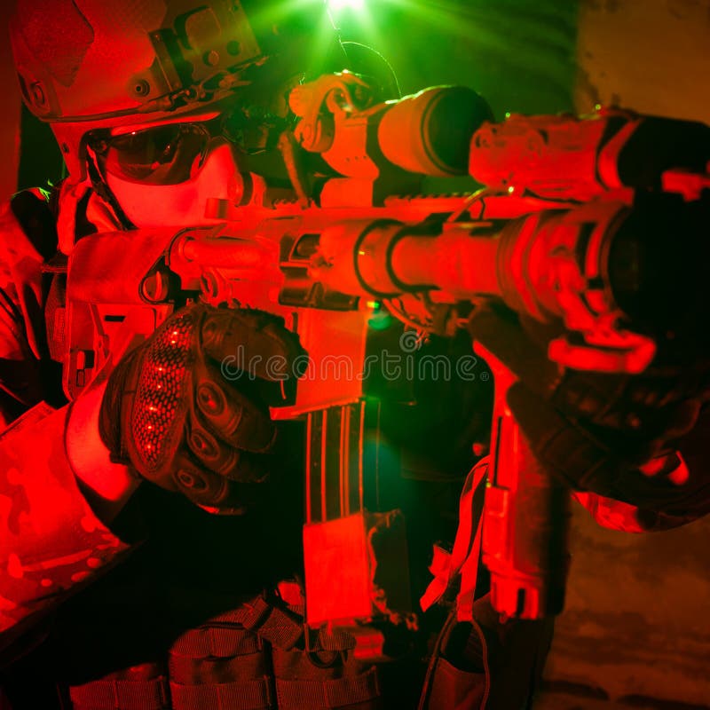 Special forces soldier or contractor during night mission/operation (red and green light for underline the atmoshpere). Special forces soldier or contractor during night mission/operation (red and green light for underline the atmoshpere)