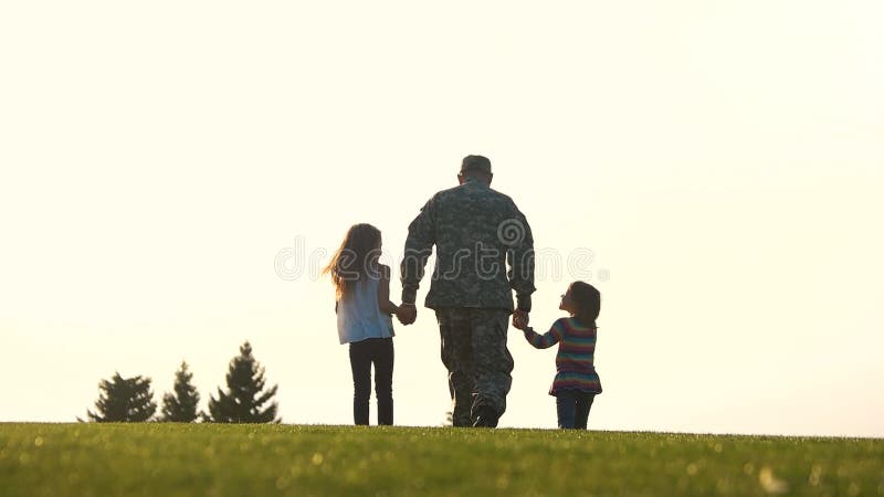 Soldat mit zwei Kindern, die Händchenhalten gehen