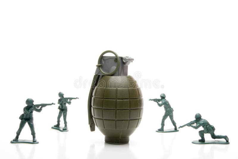 Several toy soldiers surrounding a hand grenade. Several toy soldiers surrounding a hand grenade.