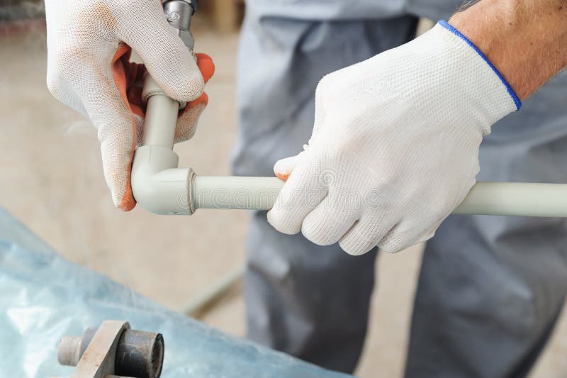 Soldering plastic pipe. stock photo. Image of heat, installation 78887634