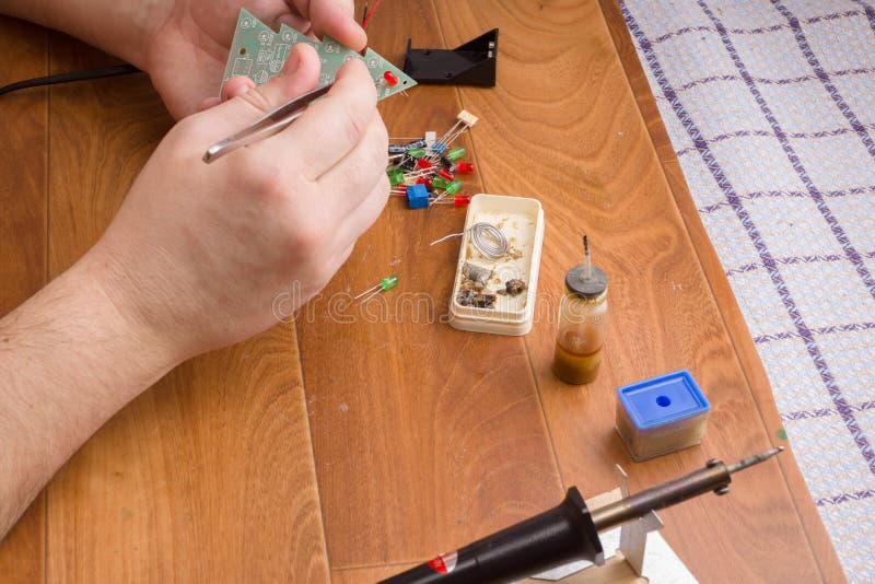 Solders a LED fir-tree stock image. Image of engineering - 64811665