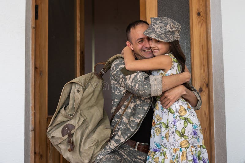 Soldier in Camouflage Playing with His Daughter at Home Stock Image
