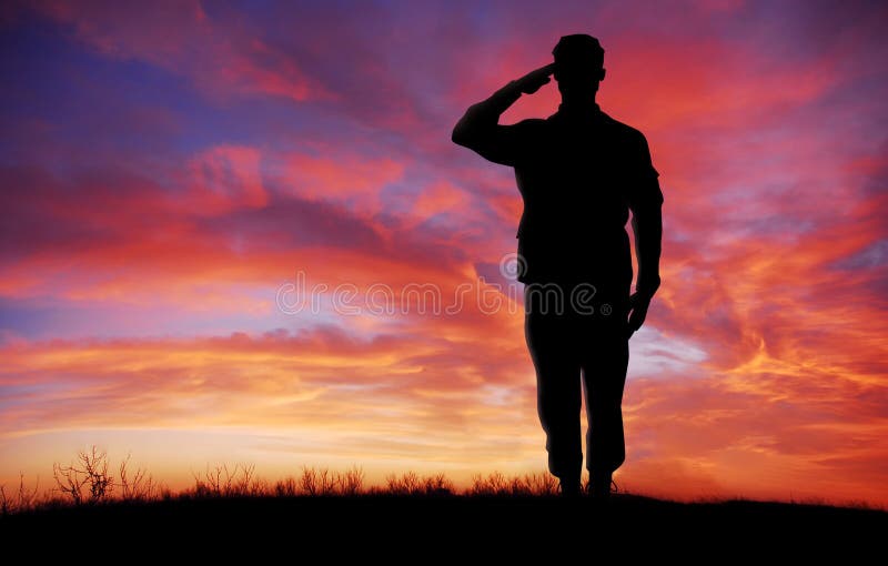 Soldier full body silhouette saluting gesture at sunset copy space