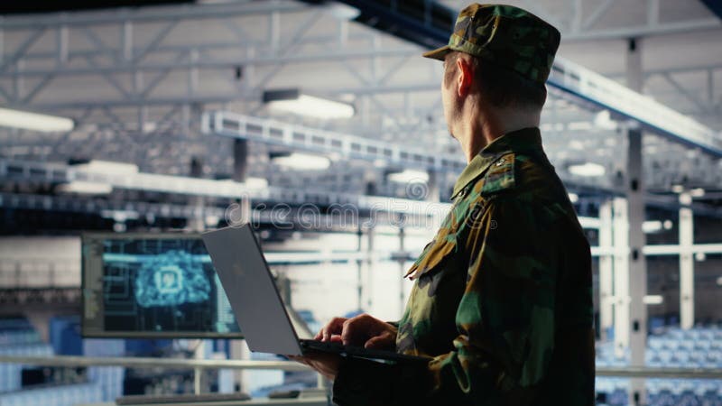 Soldier in server hub using laptop to deploy AI tech, modernizing defense stock footage