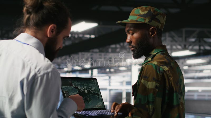 Soldier in server room uses geospatial data to support emergency operations stock video footage