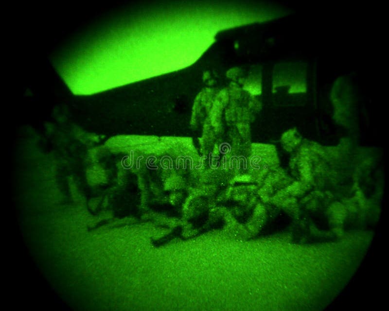 Soldiers Dismount Helicopter At Night