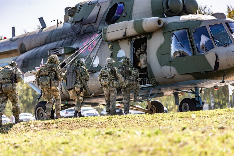 Soldiers landing at the military helicopter and special forces performing a military demonstration