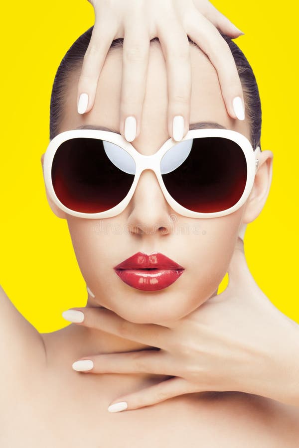 Closeup portrait of young gorgeous caucasian woman wearing sunglasses, over yellow background. Closeup portrait of young gorgeous caucasian woman wearing sunglasses, over yellow background