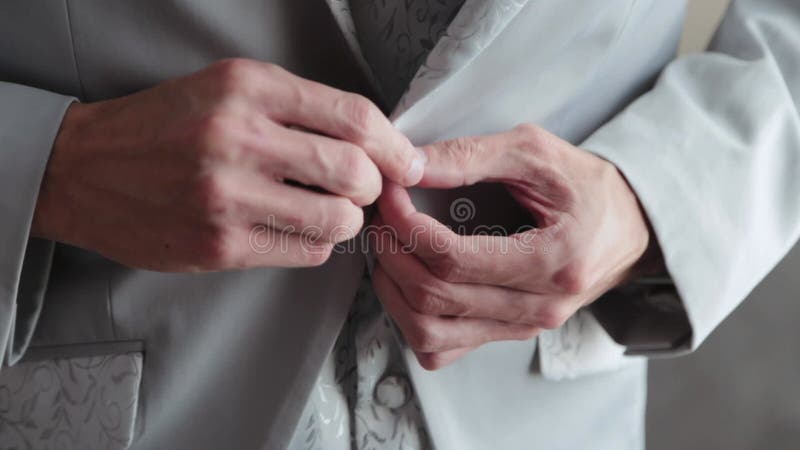 Solid businessman man buttons his jacket.