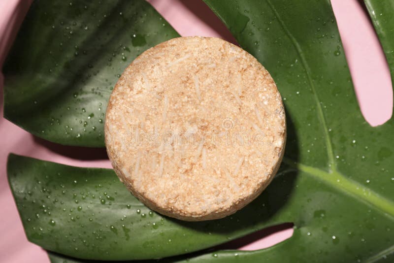 Solid Shampoo Bar and Leaf on Pink Background, Top View. Hair Care