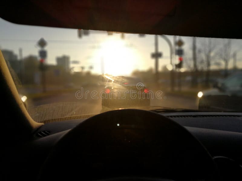 Evening sun glare through front window of the vehicle. Evening sun glare through front window of the vehicle