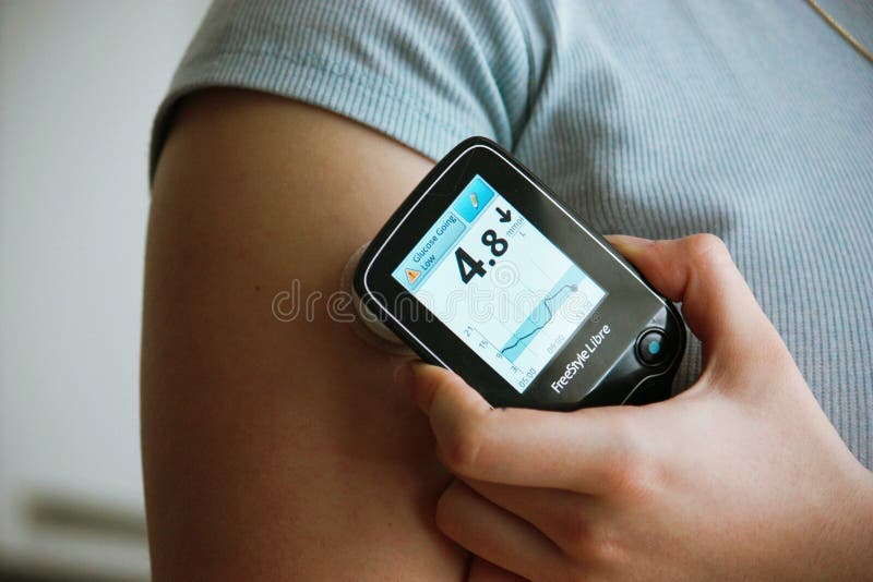 Diabetic patient measuring her blood glucose with freestyle libre