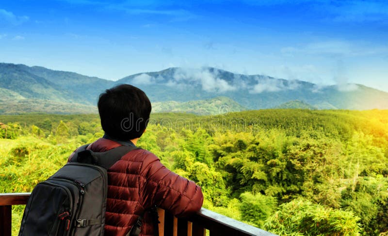 Solo traveller in front of mountain view stock photo Solo traveller in front of mountain view stock photo