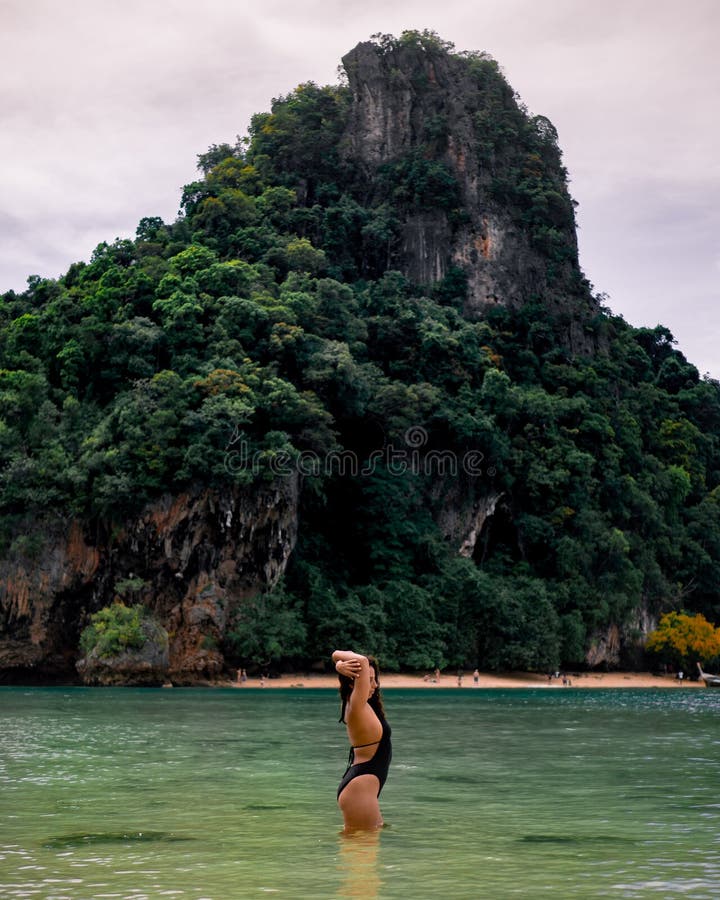 Solo female traveler enjoying the sun in Phang Nga Bay in Thailand. Solo female traveler enjoying the sun in Phang Nga Bay in Thailand