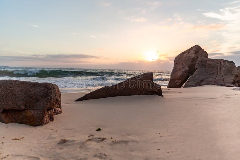 Soluppgång bland det härligt vaggar och havet royaltyfri foto Soluppgång bland det härligt vaggar och havet royaltyfri foto