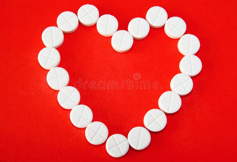 White pills form heart shape in concept image of love as the drug. White pills form heart shape in concept image of love as the drug