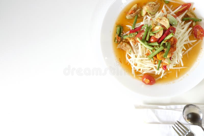 Som tam thai, green papaya salad on white table with space.