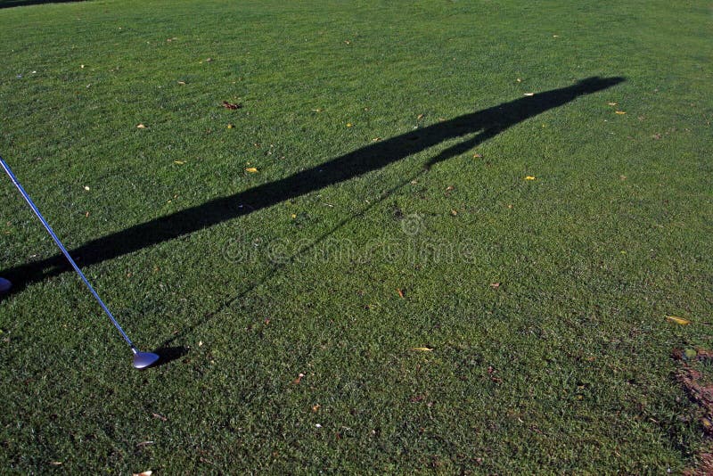 Golfer shadow with a club in hand. Golfer shadow with a club in hand