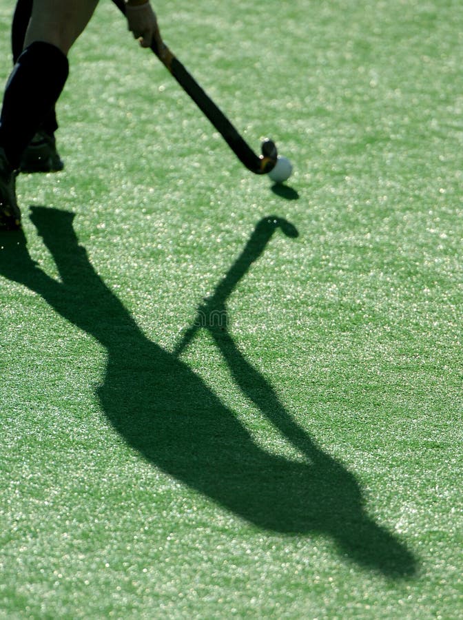 The shadow of a field hockey player as they run down the pitch. The shadow of a field hockey player as they run down the pitch.