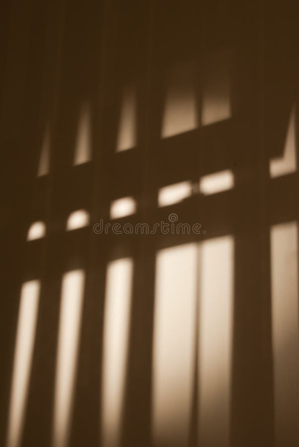 Shadows cast on a wall by a window blind. Shadows cast on a wall by a window blind