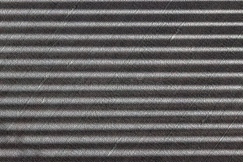 Sombras paralelas rígidas en la pared texturada gris de un obturador de rodillos de ventana o persianas fotos de archivo Sombras paralelas rígidas en la pared texturada gris de un obturador de rodillos de ventana o persianas fotos de archivo