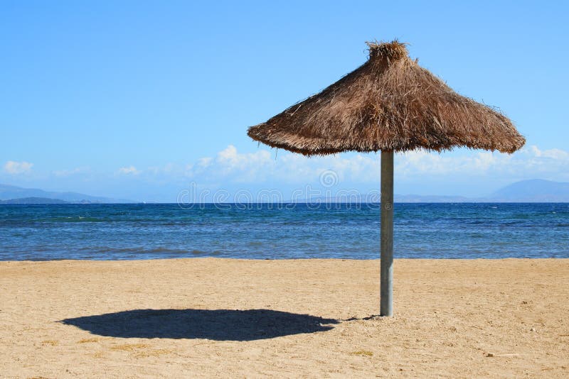 Beach and sea. Sunshade with chairs on sand. Beach and sea. Sunshade with chairs on sand