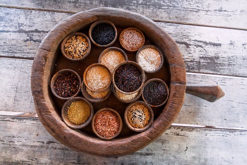 Some colorful rice sorts in wooden pot of asian kitchen. Selective focus basmati, jasmine, berry rice ready for cook stock photos Some colorful rice sorts in wooden pot of asian kitchen. Selective focus basmati, jasmine, berry rice ready for cook stock photos